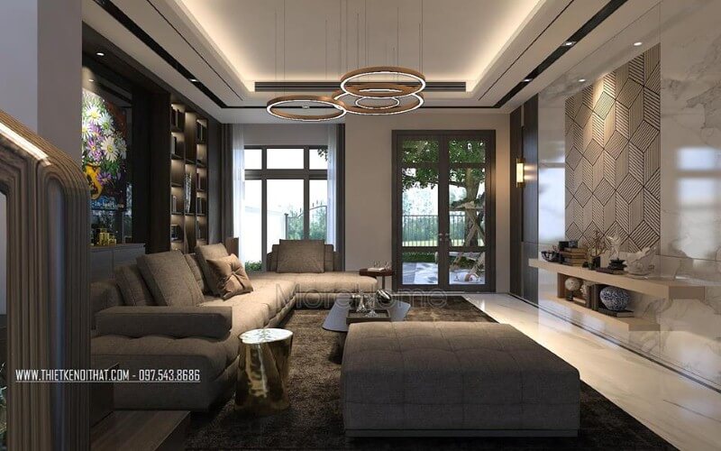 Trang trí nội thất phòng khách ấn tượng với cách kết hợp hài hòa giữa sắc trầm và sáng cùng hệ cửa kính lớn giúp không gian trở nên thông thoáng, sang trọng.