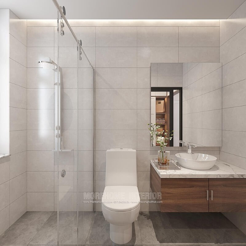 Thiết kế phòng tắm chung cư theo phong cách hiện đại đẹp với cách lựa chọn đồ vật tinh gọn nhưng lại tạo vẻ đẹp sang trọng cuốn hút từ tường ốp gạch giả bê tông, gương hiện đại không khung ốp tường, phòng tắm kính cửa trượt. Gương trang trí