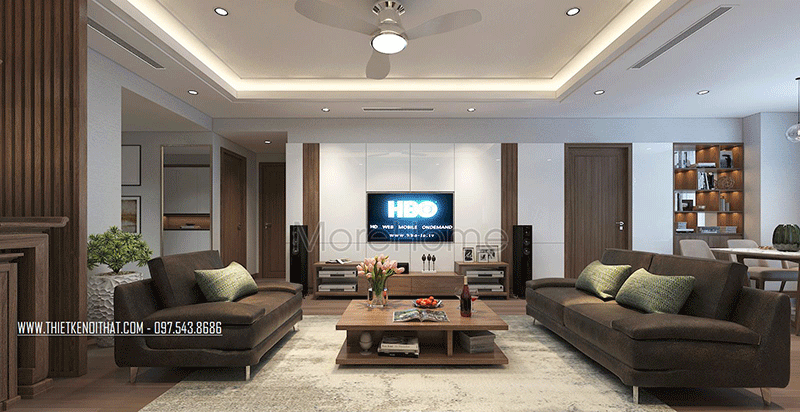 Nổi bật giữa phòng khách là bộ sofa bằng nỉ màu socola và chiếc bàn trà bằng gỗ với thiết kế độc đáo là điểm nhấn cho phòng khách chung cư Danh sách các mẫu thiết kế sofa phòng khách hiện đại đẹp nhất