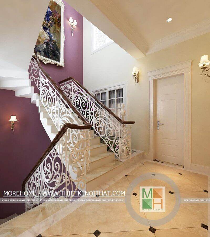 Cầu thang nhà biệt thự với thiết kế họa tiết nghệ thuật bằng sắt phủ sơn trắng kết hợp tay vịn gỗ là điểm nhấn ấn tượng cho không gian tân cổ điển Cầu thang gỗ tự nhiên